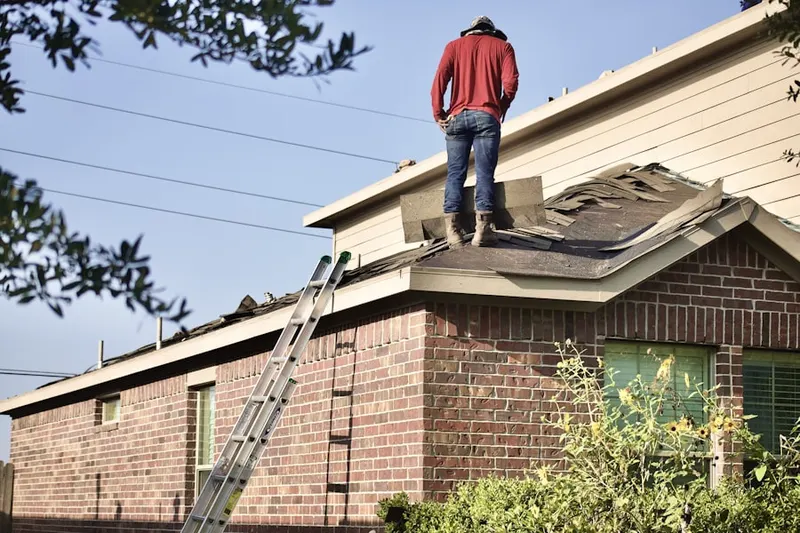 Professional roofer working on a residential roof in Estates At Fieldstone